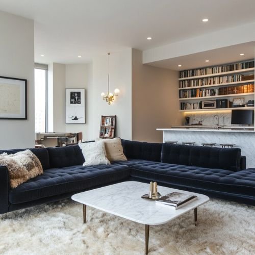 Modern Living Room Design with Dark Blue L-Shaped Sofa and Marble Table